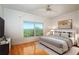 Bright bedroom with hardwood floors and a ceiling fan at 601 N Mcdonald St # 608, Mount Dora, FL 32757