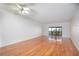Spacious living room with hardwood floors and sliding glass doors leading to balcony at 601 N Mcdonald St # 608, Mount Dora, FL 32757
