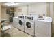 Well-equipped laundry room with multiple washers and dryers at 601 N Mcdonald St # 608, Mount Dora, FL 32757