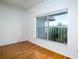 Bedroom featuring hardwood floors and a window with water views at 601 N Mcdonald St # 608, Mount Dora, FL 32757