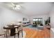 Living room with hardwood floors, staged furniture, and water views at 601 N Mcdonald St # 608, Mount Dora, FL 32757