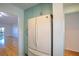 White appliances and teal cabinets in this galley-style kitchen at 601 N Mcdonald St # 608, Mount Dora, FL 32757