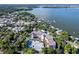 Aerial view of waterfront property, showcasing a large building and beautiful lake views at 601 N Mcdonald St # 608, Mount Dora, FL 32757