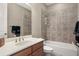 Simple bathroom with granite countertop and tiled tub at 8692 Crested Eagle Pl, Sanford, FL 32771