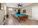 Game room with a pool table, comfortable seating, and plenty of natural light at 8692 Crested Eagle Pl, Sanford, FL 32771