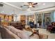 Open living room featuring hardwood floors, a cozy seating area, and a view into the kitchen at 8692 Crested Eagle Pl, Sanford, FL 32771