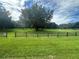 Scenic park with large trees, wooden fence, and grassy areas at 8692 Crested Eagle Pl, Sanford, FL 32771