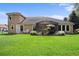 Home with a large backyard, screened patio, and lush lawn at 8692 Crested Eagle Pl, Sanford, FL 32771