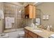 Bathroom with granite countertop and tiled shower/tub at 8692 Crested Eagle Pl, Sanford, FL 32771