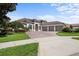 Two-story home with a three-car garage and manicured lawn at 8692 Crested Eagle Pl, Sanford, FL 32771