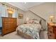 Cozy bedroom with wood furniture and floral bedding at 8692 Crested Eagle Pl, Sanford, FL 32771