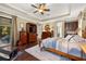 Main bedroom with king bed, built-ins, and access to backyard at 8692 Crested Eagle Pl, Sanford, FL 32771