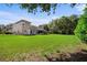 Spacious backyard with home view and lush lawn at 8692 Crested Eagle Pl, Sanford, FL 32771