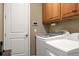 Laundry room with washer, dryer, and cabinets at 8692 Crested Eagle Pl, Sanford, FL 32771