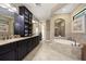Luxurious bathroom with double vanity, soaking tub, and separate shower at 8692 Crested Eagle Pl, Sanford, FL 32771