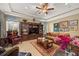 Spacious living room with hardwood floors, built-in shelving, and comfortable seating at 8692 Crested Eagle Pl, Sanford, FL 32771