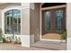 Inviting front entrance with double doors and elegant landscaping at 8692 Crested Eagle Pl, Sanford, FL 32771