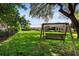 Green grassy backyard with a wooden swing at 8692 Crested Eagle Pl, Sanford, FL 32771