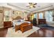 Spacious main bedroom with king-size bed, fireplace, and home gym at 8692 Crested Eagle Pl, Sanford, FL 32771