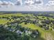 Wide aerial view of a neighborhood with lush green spaces at 32313 Oak Canopy Dr, Sorrento, FL 32776