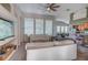 Spacious living room featuring comfortable sofas and large windows at 32313 Oak Canopy Dr, Sorrento, FL 32776