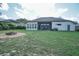 Large backyard with firepit and view of home's exterior at 32313 Oak Canopy Dr, Sorrento, FL 32776