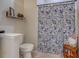 Simple bathroom with a shower, toilet, and shelf at 32313 Oak Canopy Dr, Sorrento, FL 32776