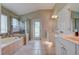 Spa-like bathroom with soaking tub and walk-in shower at 32313 Oak Canopy Dr, Sorrento, FL 32776