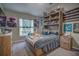 Bright bedroom featuring built-in shelves and a comfortable bed at 32313 Oak Canopy Dr, Sorrento, FL 32776