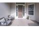 Inviting front porch with seating area and decorative rug at 32313 Oak Canopy Dr, Sorrento, FL 32776