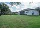 Spacious backyard with firepit and home's exterior at 32313 Oak Canopy Dr, Sorrento, FL 32776