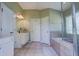 Clean bathroom with double vanity and a large soaking tub at 32313 Oak Canopy Dr, Sorrento, FL 32776