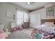 Charming bedroom with a full-size bed and decorative butterfly art at 32313 Oak Canopy Dr, Sorrento, FL 32776