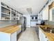 Updated kitchen with butcher block countertops and gray tile backsplash at 34035 Linda Ln, Leesburg, FL 34788