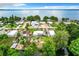 Aerial view of lakefront property with houses and lush greenery at 34035 Linda Ln, Leesburg, FL 34788