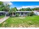 Single story home with covered porch and large grassy yard at 34035 Linda Ln, Leesburg, FL 34788
