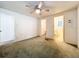 Bright bedroom featuring a ceiling fan and access to a bathroom at 34035 Linda Ln, Leesburg, FL 34788