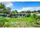 Single-story home with covered porch and lush lawn at 34035 Linda Ln, Leesburg, FL 34788