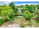 Backyard oasis with a pond, trees, and above ground pool at 34035 Linda Ln, Leesburg, FL 34788
