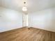 Simple bedroom with wood-look flooring and door at 34035 Linda Ln, Leesburg, FL 34788