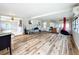 Living room with wood floors and access to other rooms at 34035 Linda Ln, Leesburg, FL 34788