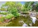 Waterfront property with lush vegetation and canal access at 34035 Linda Ln, Leesburg, FL 34788