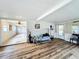 Living area with wood floors and a view of the kitchen at 34035 Linda Ln, Leesburg, FL 34788