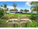 Backyard with overgrown pool and chain link fence at 34035 Linda Ln, Leesburg, FL 34788