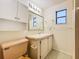 Bathroom with vanity, toilet and linen cabinet at 34035 Linda Ln, Leesburg, FL 34788