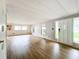 Living room with wood-look floors and access to exterior at 34035 Linda Ln, Leesburg, FL 34788