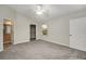 Spacious bedroom with neutral walls, gray carpet, and walk-in closet at 131 Costa Mesa Dr, The Villages, FL 32159