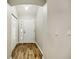 Interior entryway with white door and wood-look floors at 131 Costa Mesa Dr, The Villages, FL 32159