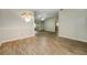 Bright dining room with chandelier and wood-look floors at 131 Costa Mesa Dr, The Villages, FL 32159