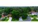 Aerial view of home nestled in a tree-lined neighborhood at 131 Costa Mesa Dr, The Villages, FL 32159